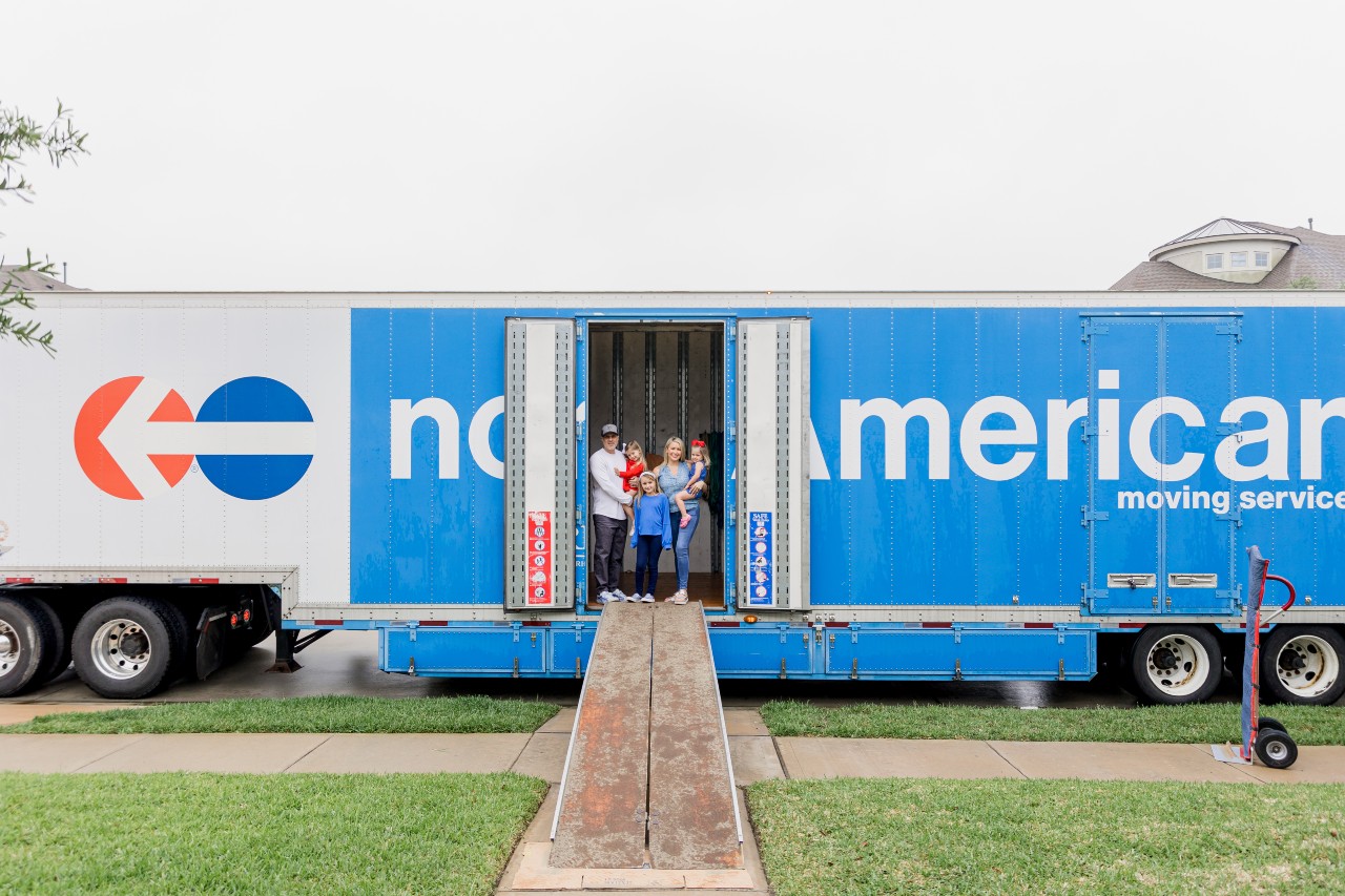north-american-moving-services-truck Family of five standing inside a North American Van Lines moving truck
