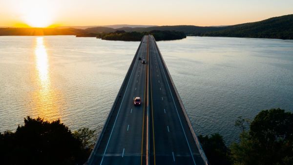 Cars driving on a bridge over large body of water